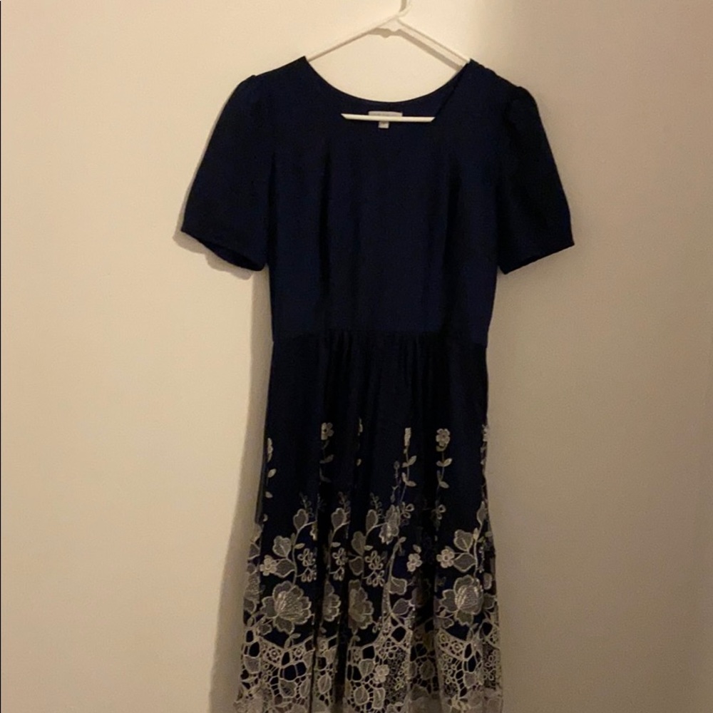 A navy blue dress with embroideries at the bottom